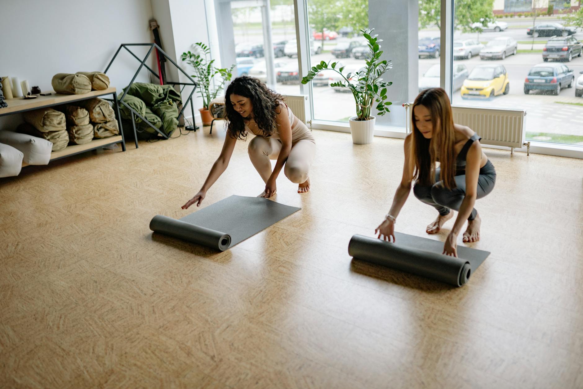 Beautiful sunlit yoga studio with plants and mats