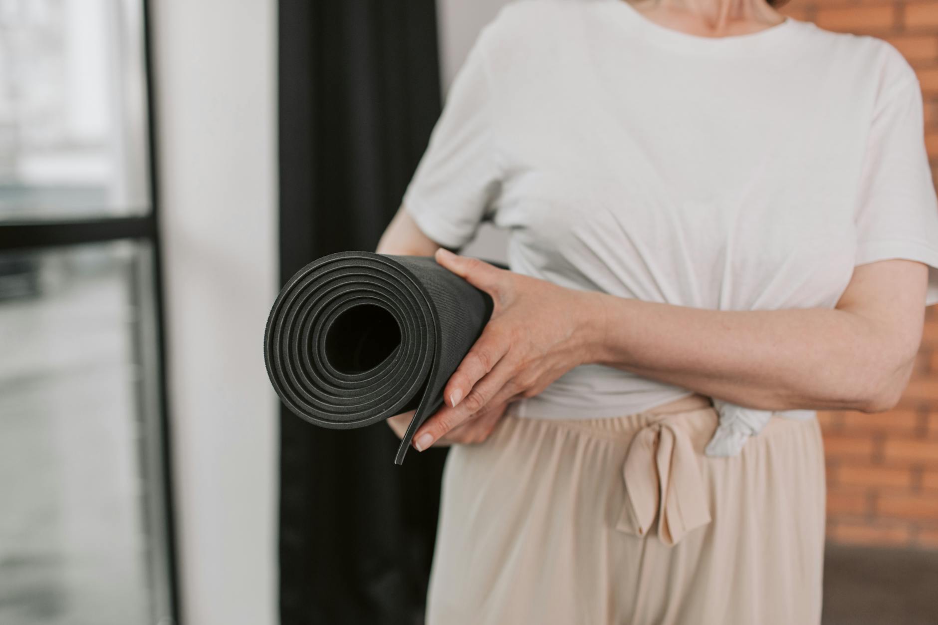 Close up of a woman hands on yoga mat